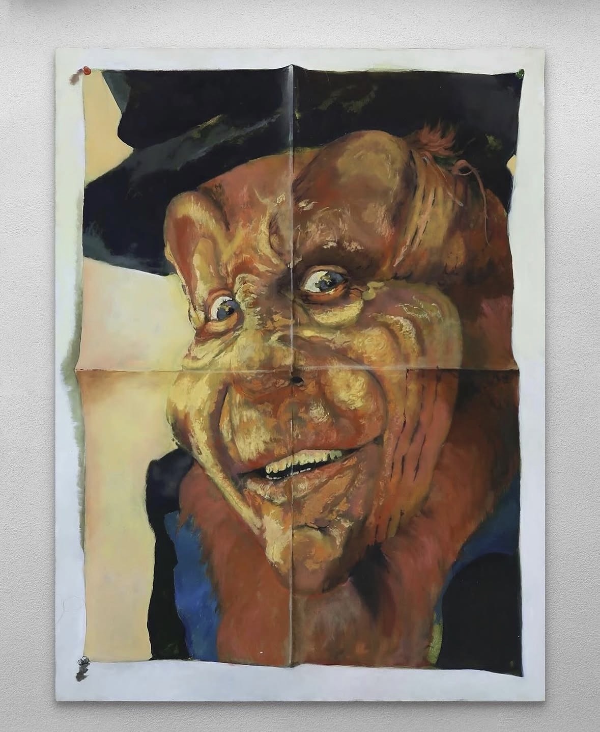 Distorted male portrait by Henry Swanson painted across a hanging surface.
